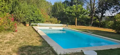 a large swimming pool in a yard with trees at Les hauts de Palaja, villa with pool and parking in Palaja