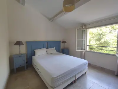 a bedroom with a white bed and a window at La Redorte 23 in La Redorte