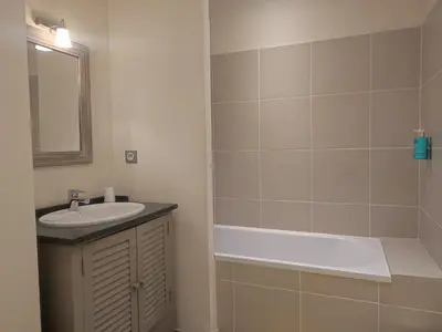 a bathroom with a sink and a bath tub at La Redorte 23 in La Redorte