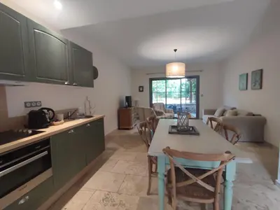 a kitchen and living room with a table and chairs at La Redorte 23 in La Redorte
