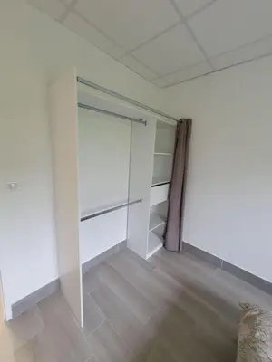 a room with white walls and a sliding door at L'arche rose in Nailloux