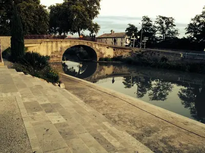 a bridge over a river with a tunnel at La maison du canal in Ventenac en Minervois