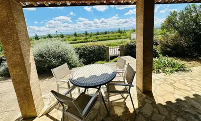 a table and chairs sitting on a patio at La maison du canal in Ventenac en Minervois