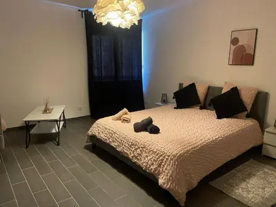 a bedroom with a bed with a teddy bear on it at les bambous in Mas-Saintes-Puelles