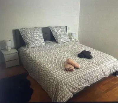 a bed with two flip flops and a pair of shoes on it at les bambous in Mas-Saintes-Puelles