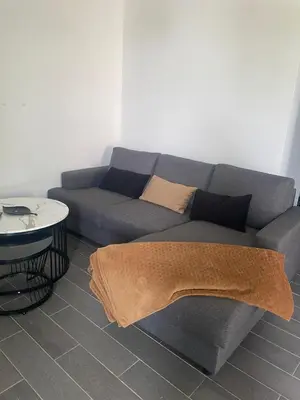 a living room with a couch and a table at les bambous in Mas-Saintes-Puelles