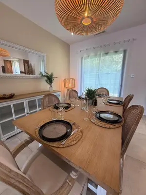 a patio with two chairs and a table next to a pool at New villa 2025 Pyrenees View, Pool & Comfort in Carcassonne