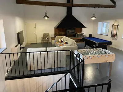 a living room with a couch and a piano at Le Grand Gîte in Le Soulié
