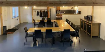 a large wooden table and chairs in a kitchen at Le Grand Gîte in Le Soulié