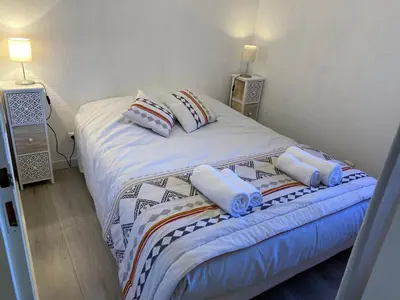 a bedroom with a bed with two pillows on it at Le Grand Gîte in Le Soulié