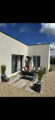 a house with a patio with a table and chairs at La Maison Belle Étoile in Limoux