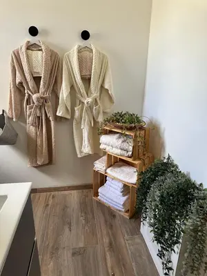 a room with three coats hanging on a wall at La Maison Belle Étoile in Limoux