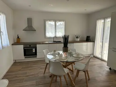 a kitchen with a dining room table and chairs at La Maison Belle Étoile in Limoux