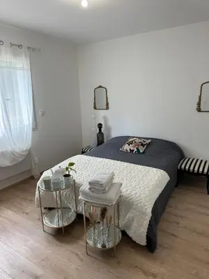 a bedroom with a bed and two end tables at La Maison Belle Étoile in Limoux