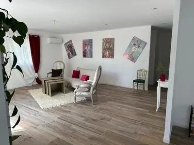 a living room with a couch and a table and chairs at La Maison Belle Étoile in Limoux
