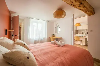 a bedroom with a large bed with two stuffed animals on it at La Bastide - Terrasse - Jacuzzi in Carcassonne