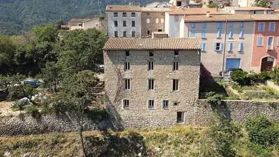an old stone building on the side of a hill at CROUXETO Chambres d'hôte in Duilhac