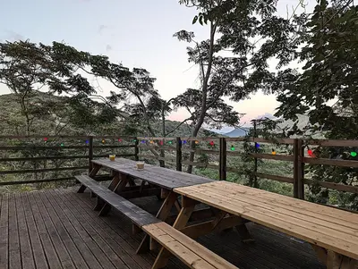 a wooden picnic table sitting on a wooden deck at CROUXETO Chambres d'hôte in Duilhac