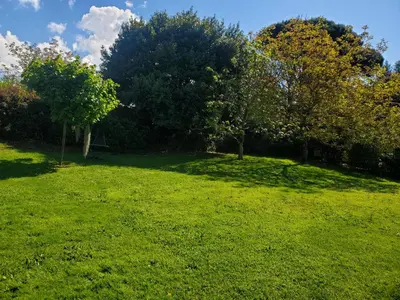 a field of green grass with trees in the background at Villa privée au calme avec gand jardin et terrasse in Bout-du-Pont-de-Larn