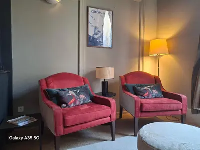 two red chairs and a lamp in a room at The Cozy 42 stylish apartment in Carcassonne