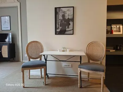 a table with two chairs and a table with a table and two chairs at The Cozy 42 stylish apartment in Carcassonne