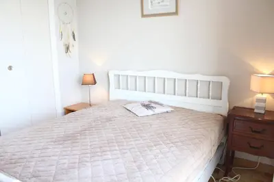 a bedroom with a large white bed with two lamps at Port la Nouvelle - Appartement 3 pièces PN550-023 in Port-la-Nouvelle