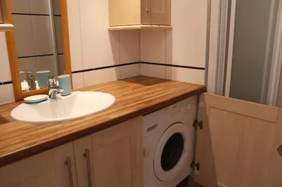 a bathroom with a sink and a washing machine at Port la Nouvelle - Appartement 3 pièces PN550-023 in Port-la-Nouvelle