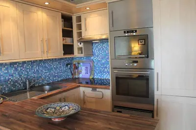 a kitchen with a sink and a stove top oven at Port la Nouvelle - Appartement 3 pièces PN550-023 in Port-la-Nouvelle