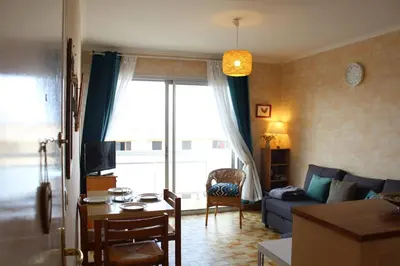 a living room with a couch and a table at Port la Nouvelle - Appartement 3 pièces PN550-023 in Port-la-Nouvelle