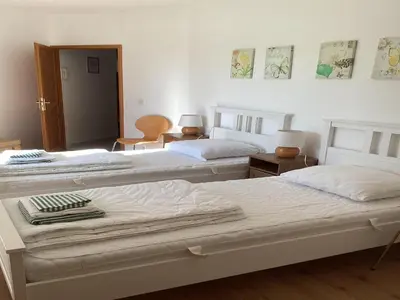 two beds in a room with white walls at Villa in France with Private Pool & Garden in Prades-sur-Vernazobre