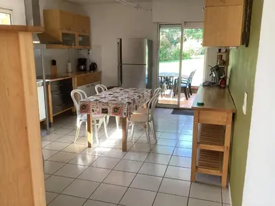 a kitchen with a table and chairs and a kitchen with a table at Villa in France with Private Pool & Garden in Prades-sur-Vernazobre