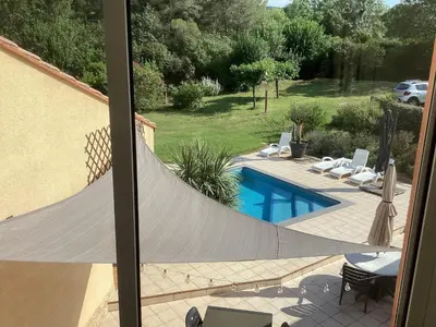 a view from a window of a swimming pool with a net at Villa in France with Private Pool & Garden in Prades-sur-Vernazobre
