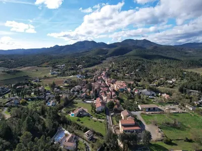 an aerial view of a small village in the mountains at Villa in France with Private Pool & Garden in Prades-sur-Vernazobre