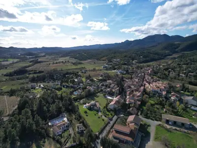 an aerial view of a small village in the mountains at Villa in France with Private Pool & Garden in Prades-sur-Vernazobre