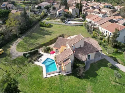 an aerial view of a house with a swimming pool at Villa in France with Private Pool & Garden in Prades-sur-Vernazobre