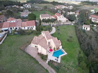 an aerial view of a house with a swimming pool at Villa in France with Private Pool & Garden in Prades-sur-Vernazobre