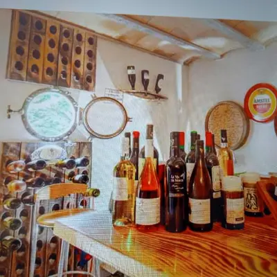 a bunch of bottles of wine sitting on a table at Chez Hélène et Michel in Preixan