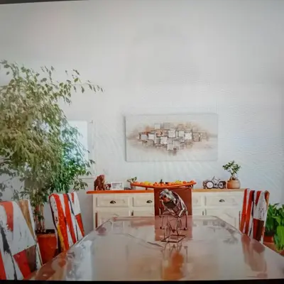 a kitchen with a table and some chairs at Chez Hélène et Michel in Preixan