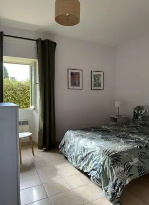 a bedroom with a bed and a window at Domaine Saint Antoine in Rieux-Minervois