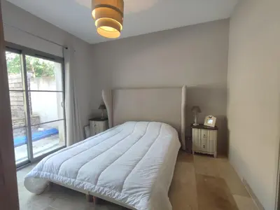 a white bedroom with a large bed and a window at la redorte 25 in La Redorte