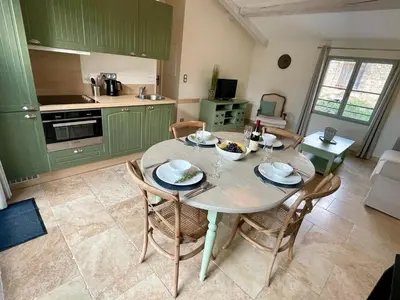 a kitchen with a table and chairs in a room at La Redorte 28 in La Redorte