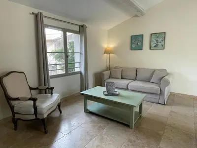 a living room with a couch and a table and a chair at La Redorte 28 in La Redorte