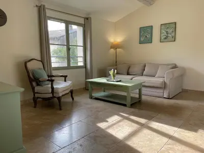 a living room with a couch and a table and a chair at La Redorte 28 in La Redorte