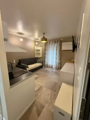 a small living room with a couch and a kitchen at studio centre ville in Narbonne