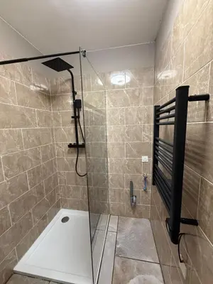 a shower with a glass door in a bathroom at studio centre ville in Narbonne
