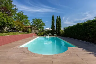 a swimming pool in the middle of a yard at L'Échappée Belle - Grande Maison, Jardin & Piscine in Castres