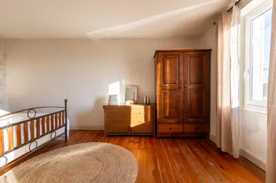 a bedroom with a bed and a dresser and a window at L'Échappée Belle - Grande Maison, Jardin & Piscine in Castres