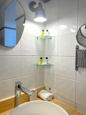 a bathroom with a sink and a mirror at L'Échappée Belle - Grande Maison, Jardin & Piscine in Castres