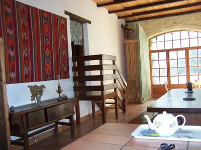 a room with a table and a chair and a tea pot at maison des Géraniums in Trausse