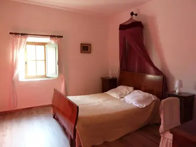 a bedroom with a bed and a window at maison des Géraniums in Trausse
